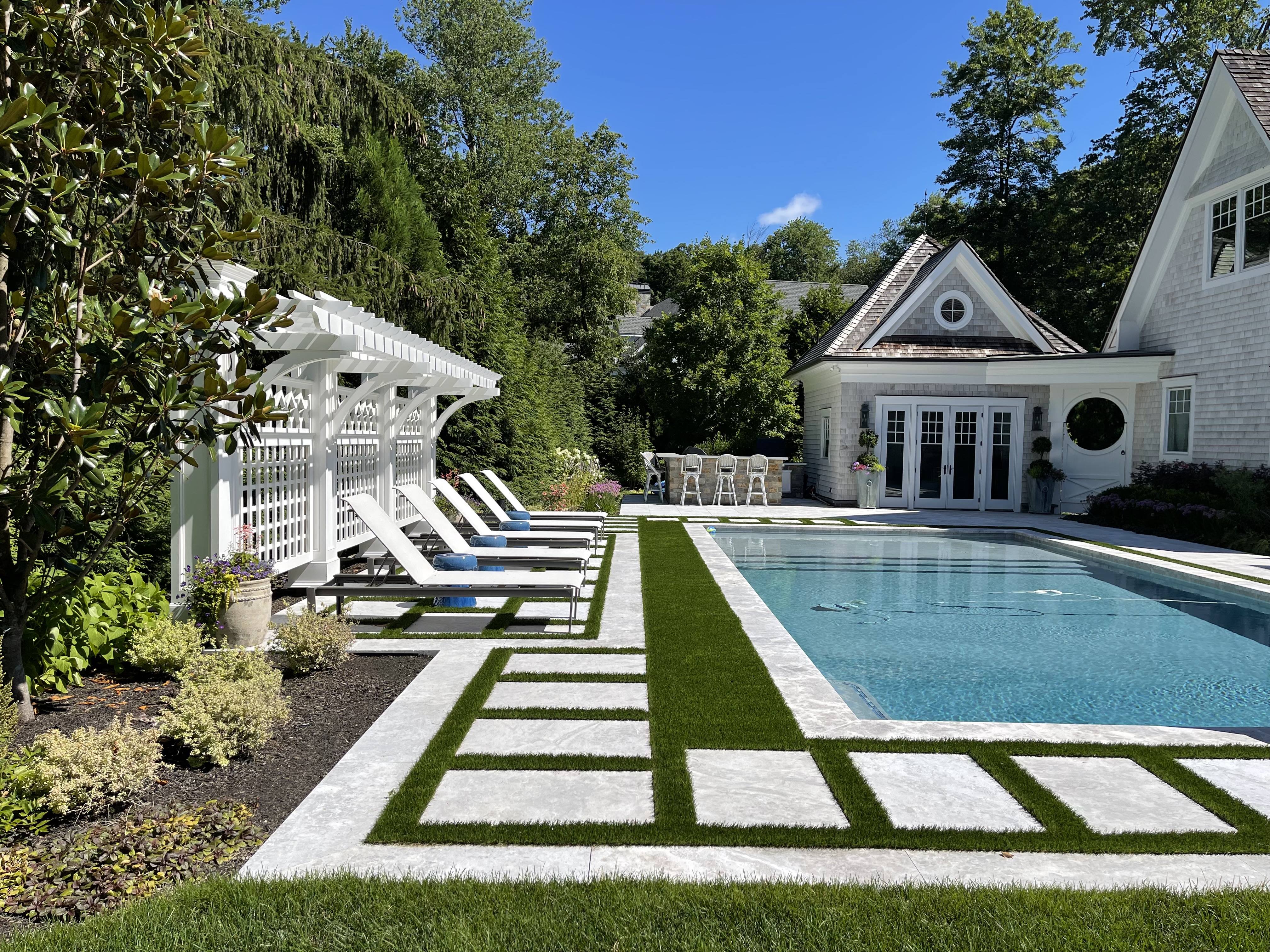Rectangle pool with stepping stones and white pergola