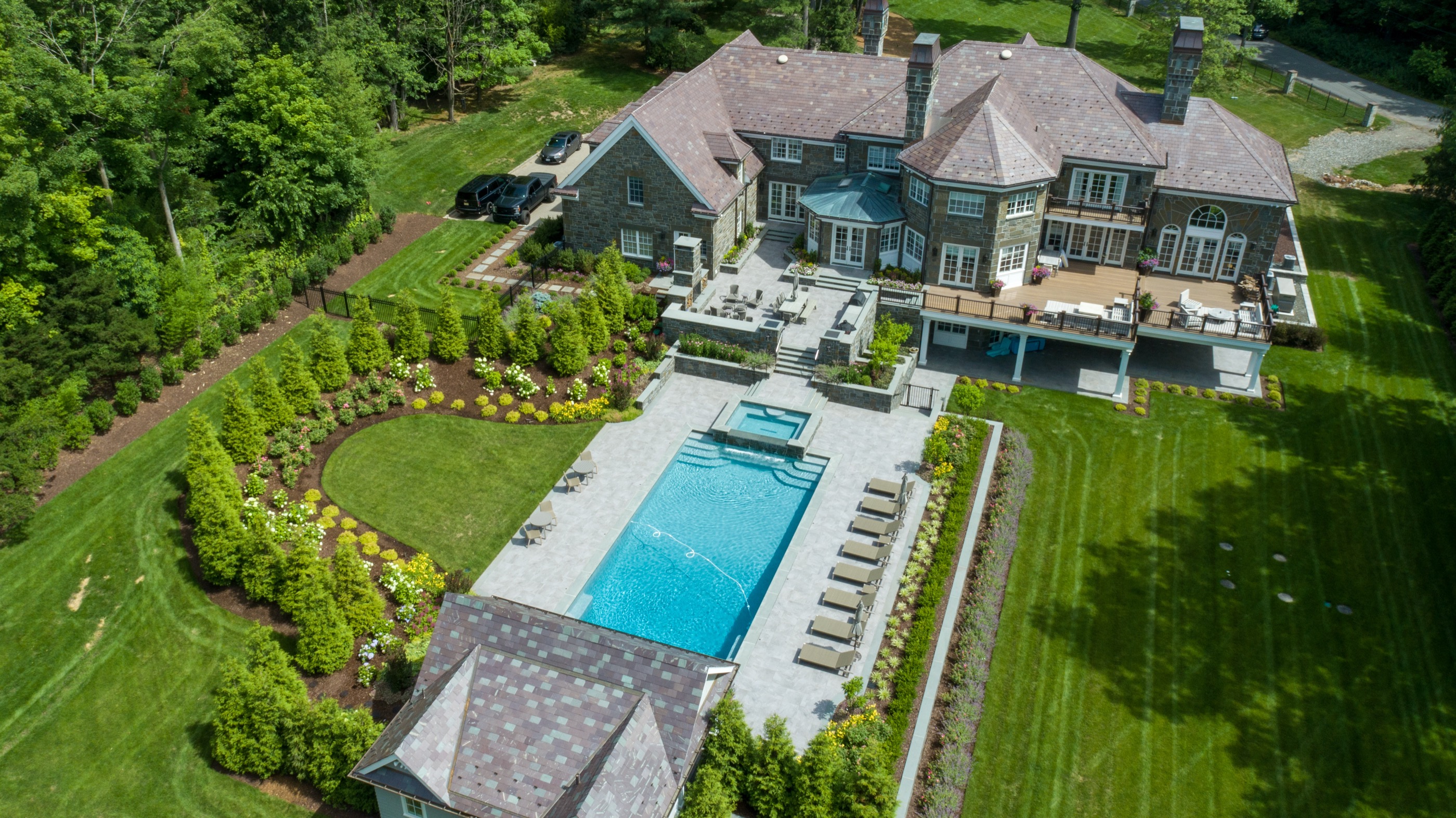 Aerial view of estate with rectangle pool, spa, and patio