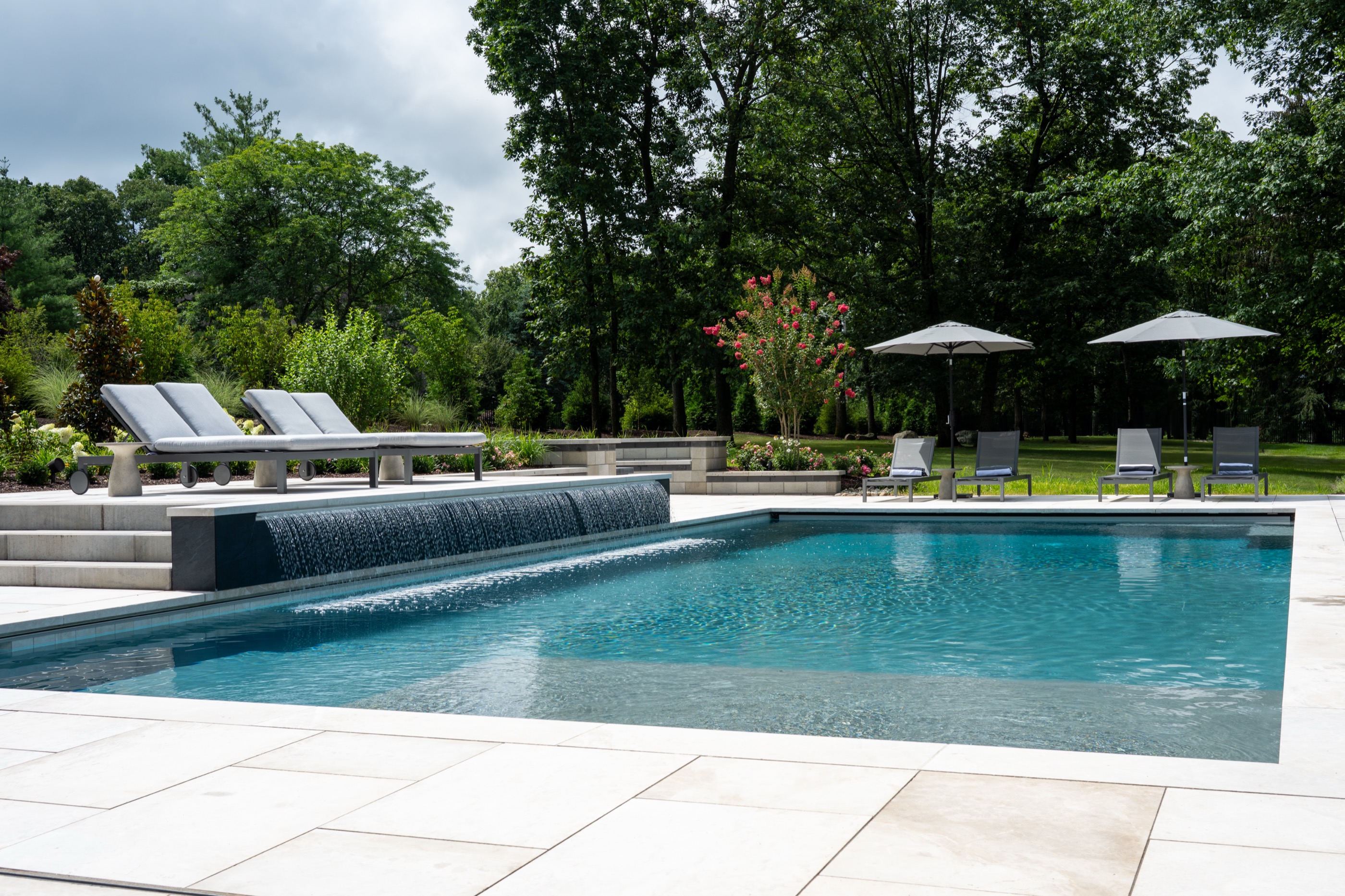 Modern geometric pool with rain curtain water feature