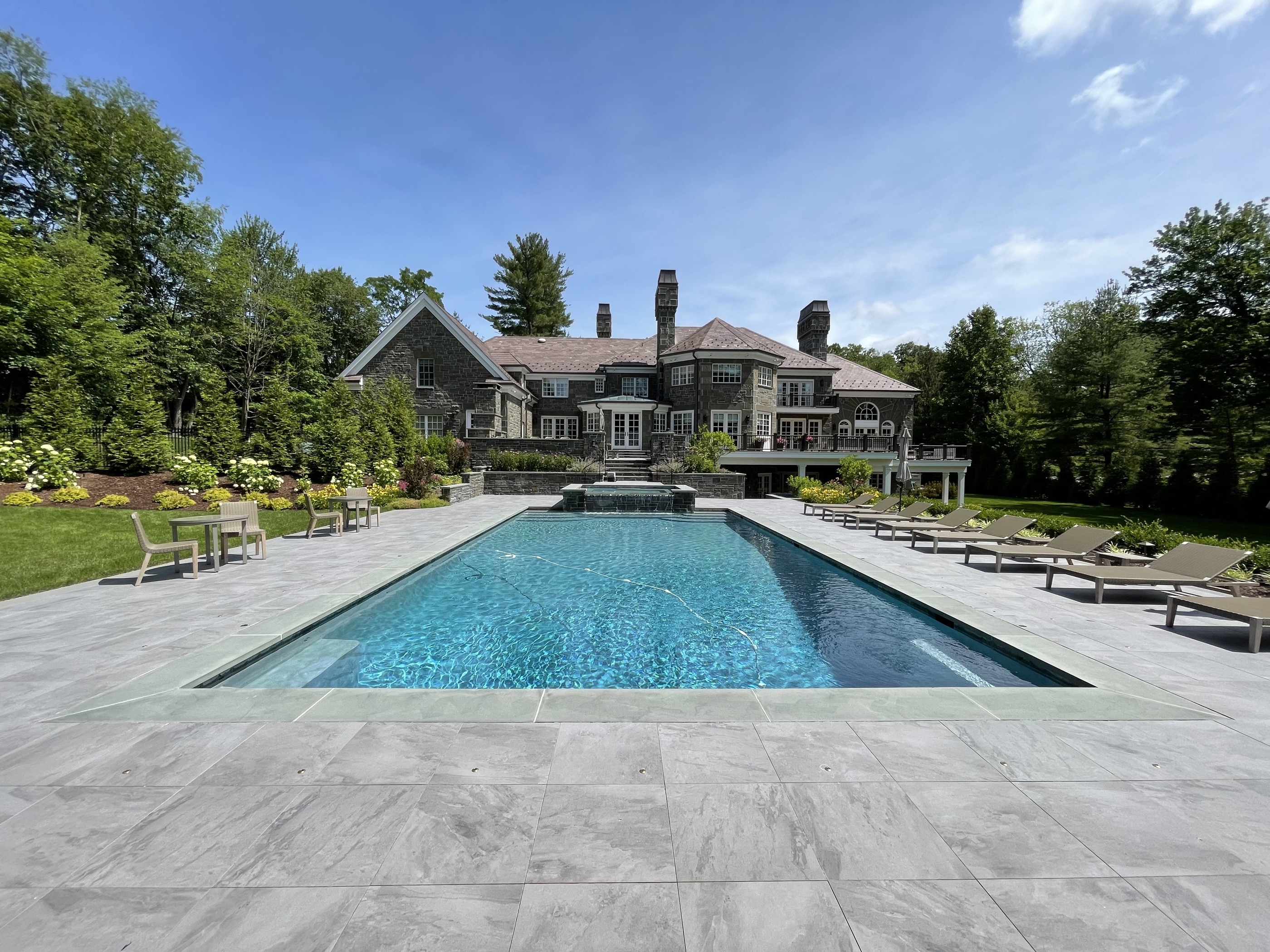 Stone manor estate with large rectangle pool