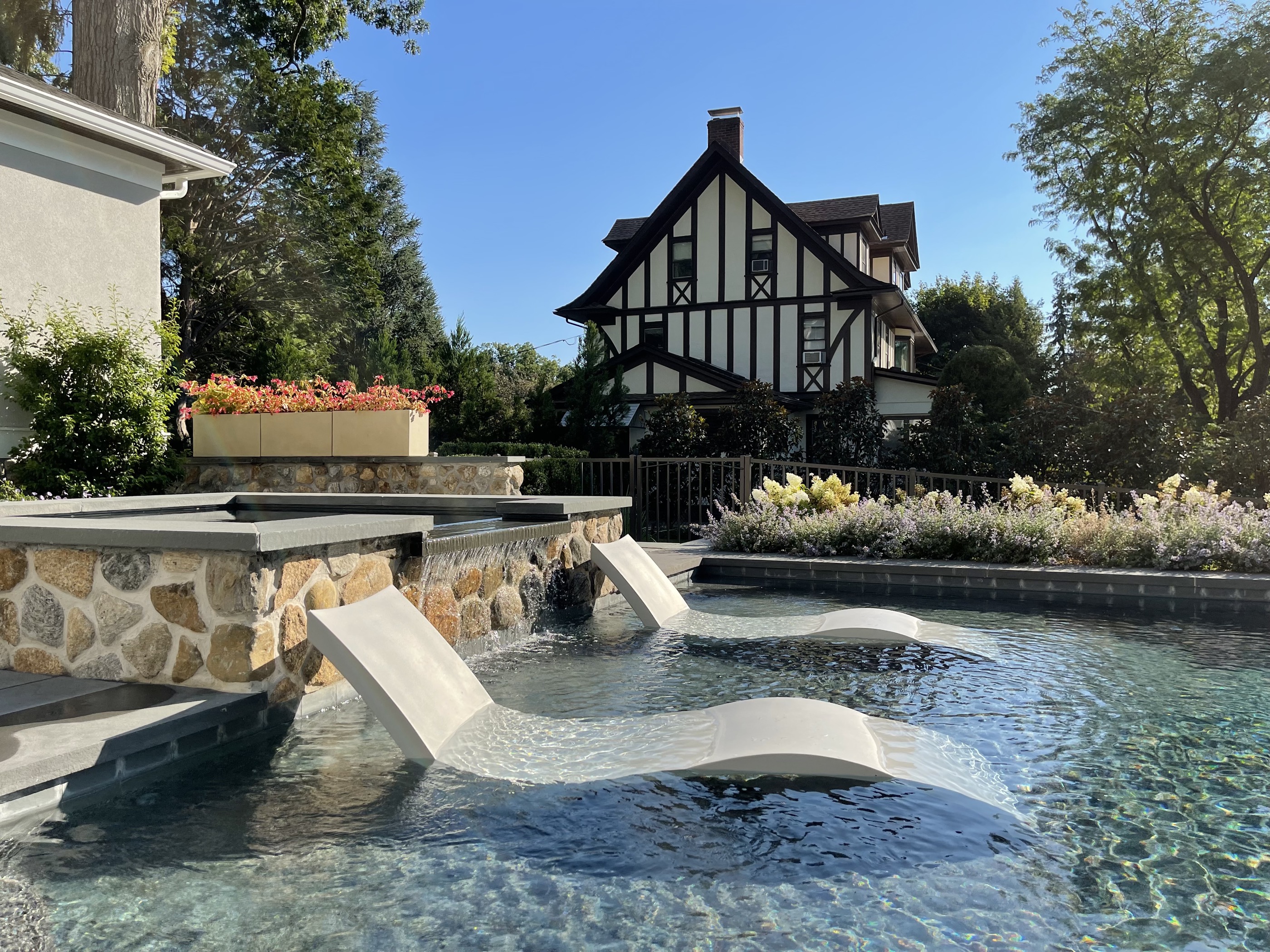 Tudor estate pool with raised spa and waterfall